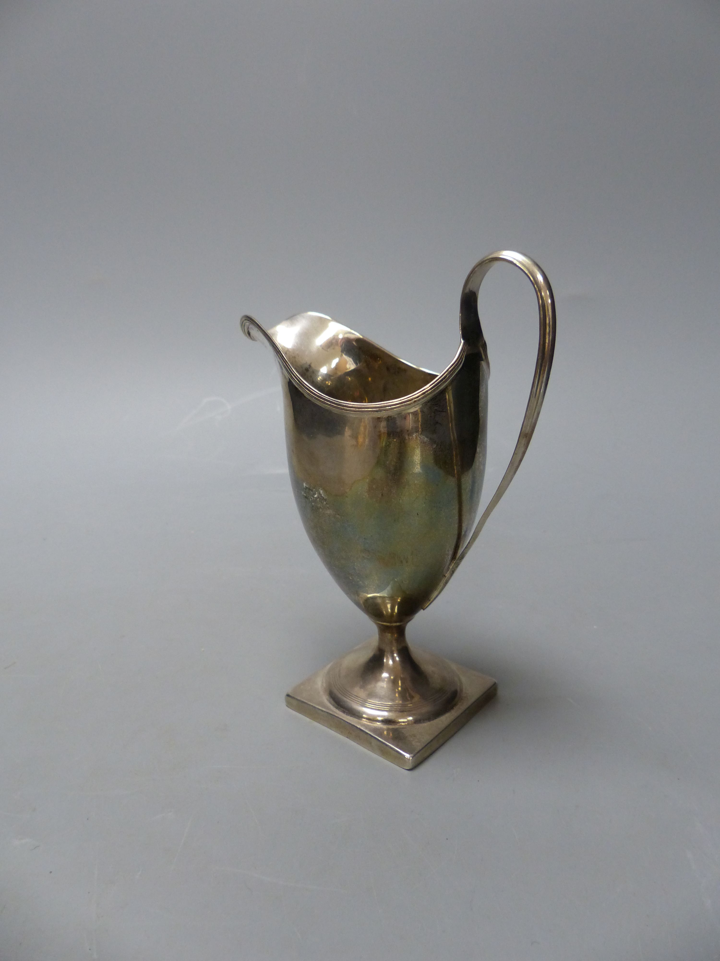 A George III silver helmet shaped cream jug, I.B, London, 1800, 14.9cm